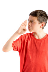 Young teenage boy isolated on a white background wafting a smell away