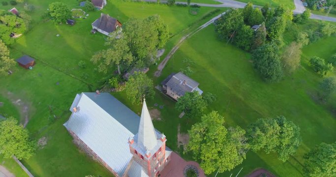 Old catholic church building. Aerial footage. Camera around.