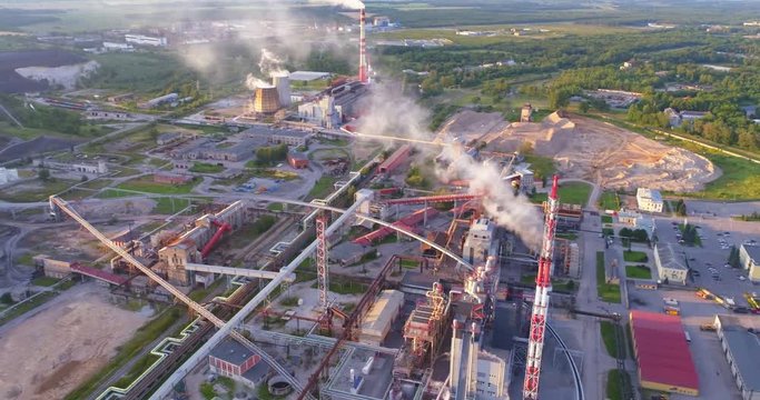 Aerial view Oil refinery with a background of mountains and sky at sunset. Aerial footage.