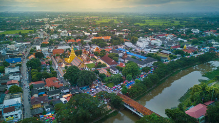 Fototapeta premium Aerial view lamphun city and People walking on lamphun walk street or night market. tourist attraction in lamphun