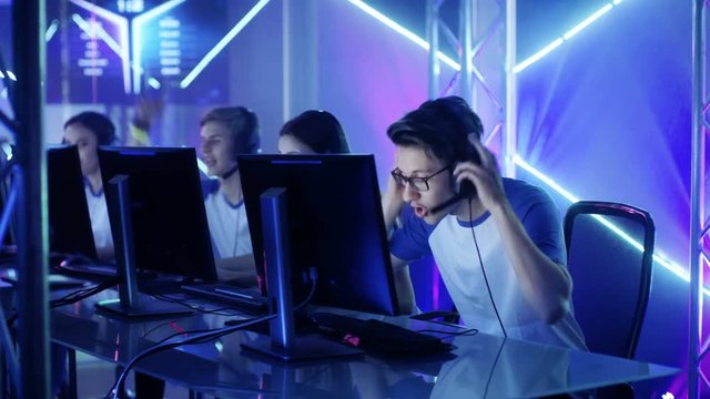 Team of Professional eSport Gamers Playing in Competitive Video Games on a Cyber Games Tournament. They Win Big. Shot on RED EPIC-W 8K Helium Cinema Camera.