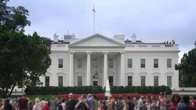 WASHINGTON, D.C. - Circa August, 2017 - A daytime exterior establishing shot of the north side of the White House with tourists on Pennsylvania Avenue in the foreground.  	