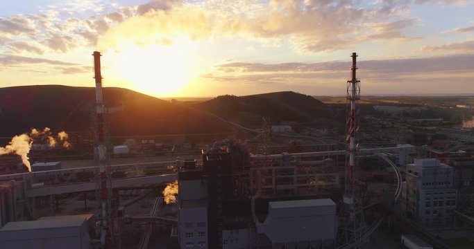 Aerial view Oil refinery with a background of mountains and sky at sunset. Aerial footage.