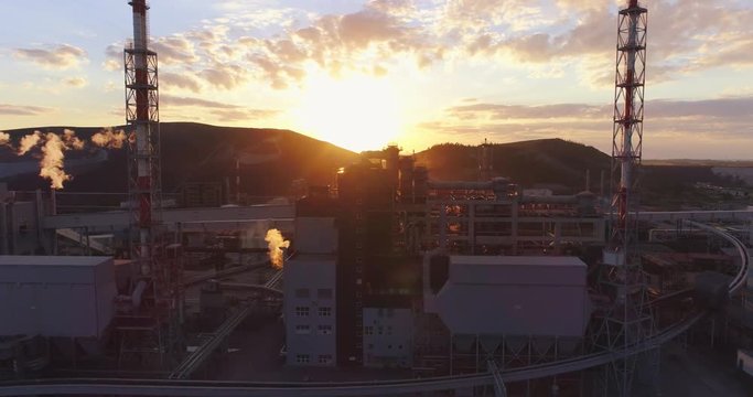 Aerial view Oil refinery with a background of mountains and sky at sunset. Aerial footage.