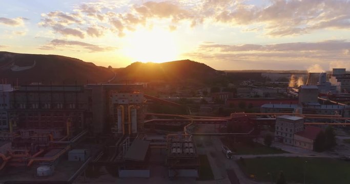 Aerial view Oil refinery with a background of mountains and sky at sunset. Aerial footage.