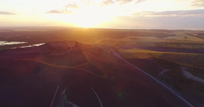 Aerial view Oil refinery with a background of mountains and sky at sunset. Aerial footage.