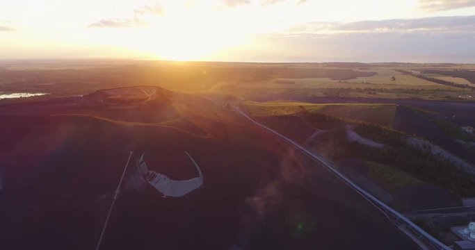 Aerial view Oil refinery with a background of mountains and sky at sunset. Aerial footage.