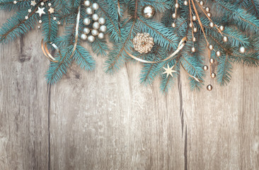 Christmas background with decorated fir tree branch border on wood