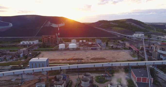 Aerial view Oil refinery with a background of mountains and sky at sunset. Aerial footage.