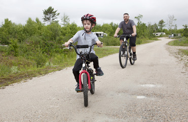 Fototapeta premium father and son on bikes