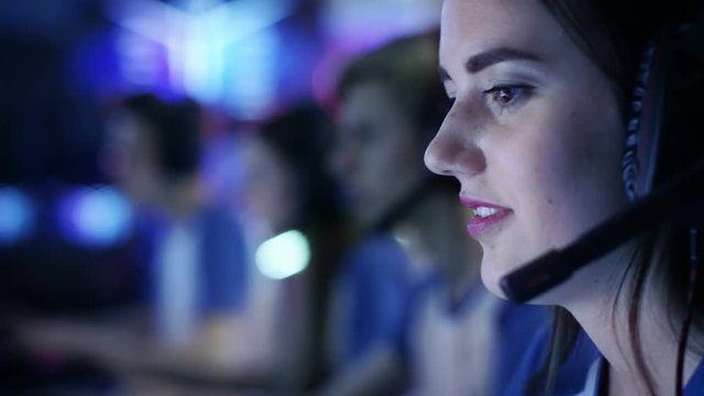 Team of Professional eSport Gamers Playing in Competitive Video Games on a Cyber Games Tournament. They Talk to Each other into Microphones. Shot on RED EPIC-W 8K Helium Cinema Camera.