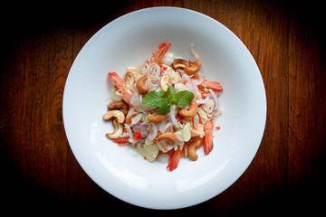 Spicy prawn salad with lemongrass. Cashews nut, onion, mix together with sour and sweet salad dressing in thai style.