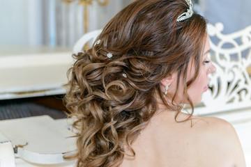 Young attractive bride on wedding gown in studio