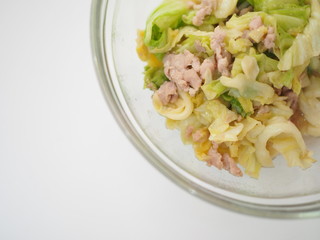 Thai local homemade stir fried minced pork with green cabbage, in glass bowl, white background