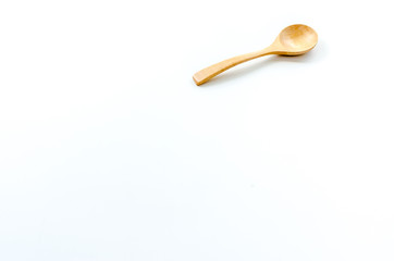 Wooden spoon on the white background