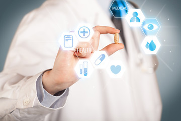 A doctor in white holding a pill