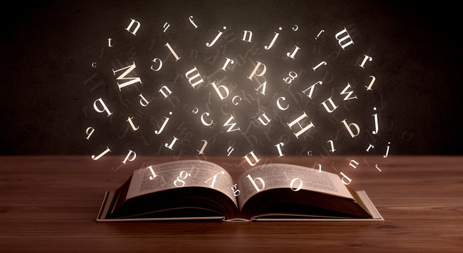 Alphabet letters over book
