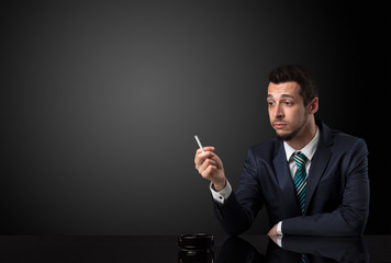 Businessman holding cigarette.