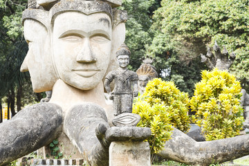 Fototapeta na wymiar Hindu and Buddhist statue in Xieng Khuan temple buddha park , Vientiane Laos