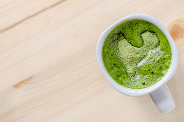 Milk green tea on wooden table