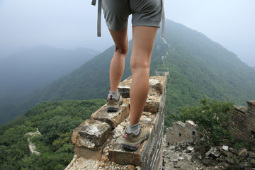 successful woman hiker enjoy the view on the top of great wall