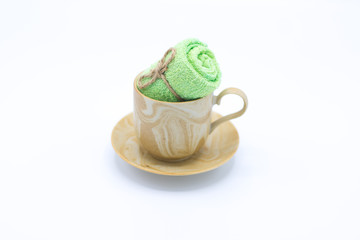 Towel in coffee cup isolated on white.