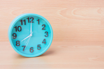Green clock on wood background , Clock to tell time Create a plan to manage the hustle of life or...