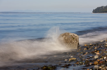 Milky Smooth Wave Hitting a Rock on the Pacific Ocean