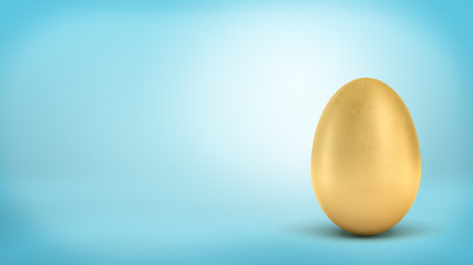 3d rendering of a whole golden egg with metallic reflection on blue background.