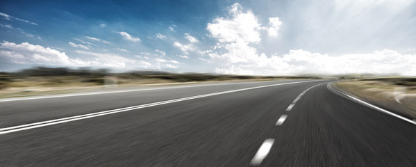 empty road and cityscape of modern city against cloud sky