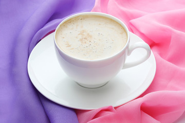 Cup of coffee on pink and violet
