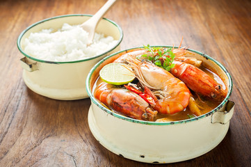 Thai food, River prawn spicy soup or tom yum goong on wooden table