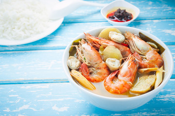 Thai food, River prawn spicy soup or tom yum goong on wooden table