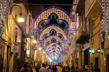 Obraz premium Pisticci (Matera, Italy) - A white town on the badlands hills, in province of Matera, Basilicata region, southern Italy, during the Saint Rocco patron feast