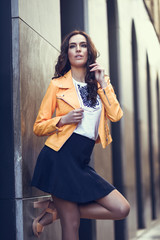 Fototapeta premium Young brunette woman in urban background.