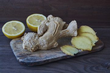 Ginger root and lemon on wooden background