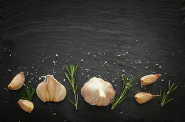Image of garlic and rosemary on slate stone plate