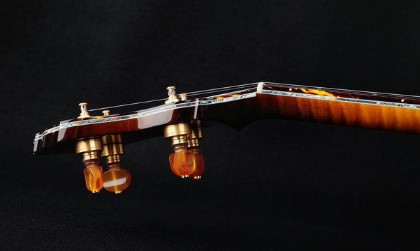 Mahogany banjo luxury gold inlaid with mother of pearl on a black background