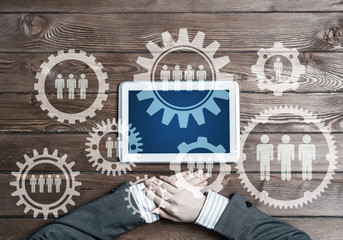 Concept of teamworking and connection with gears mechanism and tablet pc