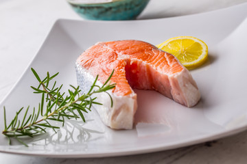 Salmon. Raw salmon steak with rosemary lemon salt and pepper