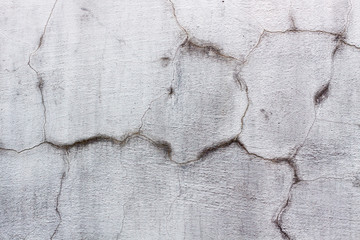 cracked concrete wall covered with gray cement texture as background for design