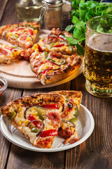 Slices of pizza with bacon, paprika and corn