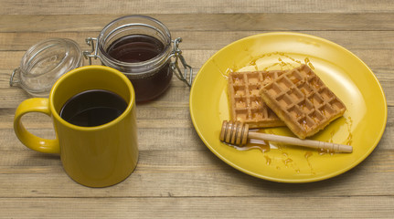 Viennese waffles with mug coffee and jar honey