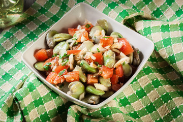 Broad bean salad with tomatoes, onion and olive