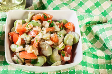 Broad bean salad with tomatoes, onion and olive