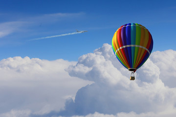 Aerostat floating in day sky. Mixed media