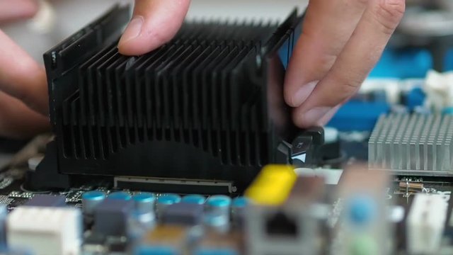 Removing And replacing CPU cooler on modern PC computer motherboard. Installing and removing radiator CPU on the motherboard.