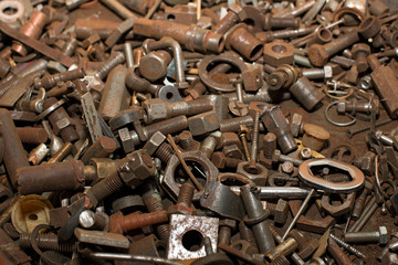 Industrial background of a pile of old rusty hardware