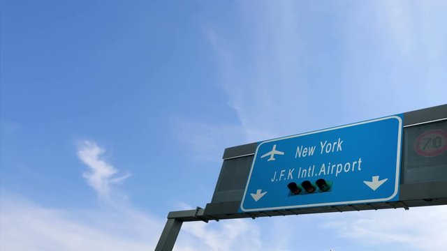 airplane flying over new york airport signboard