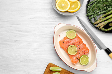 Fresh salmon fillet with peppers mix and lime in baking dish